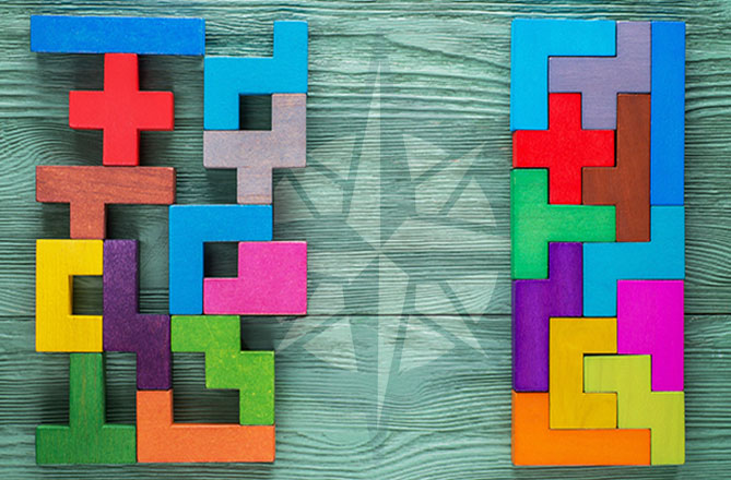 Image of multicolored wooden puzzle pieces being fit together with Orbis CRE logo in the background